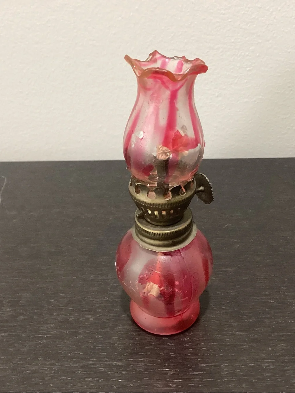 Vintage miniature glass kerosene oil lamp with distinctive light pink and dark
